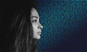 profile of a woman with a gradient background of binary code
