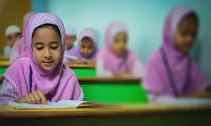 wide shot of children studying in a classroom