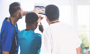 healthcare workers examining a medical scan