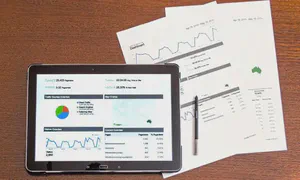 Analytics charts on paper and a tablet