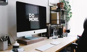 photo of computer monitor on desk with the message 'do more'