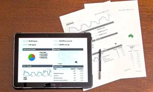 Analytics charts on paper and a tablet