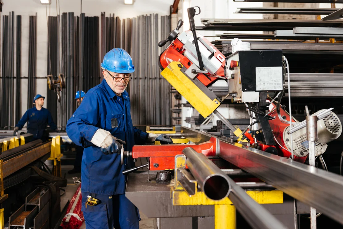 A production operative cutting a tube to a custom length