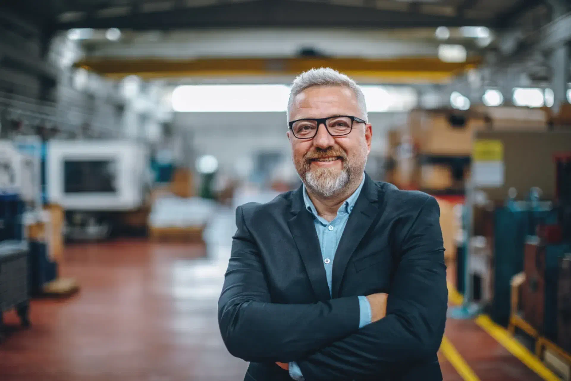 A shop floor manager standing in a fabrication workshop