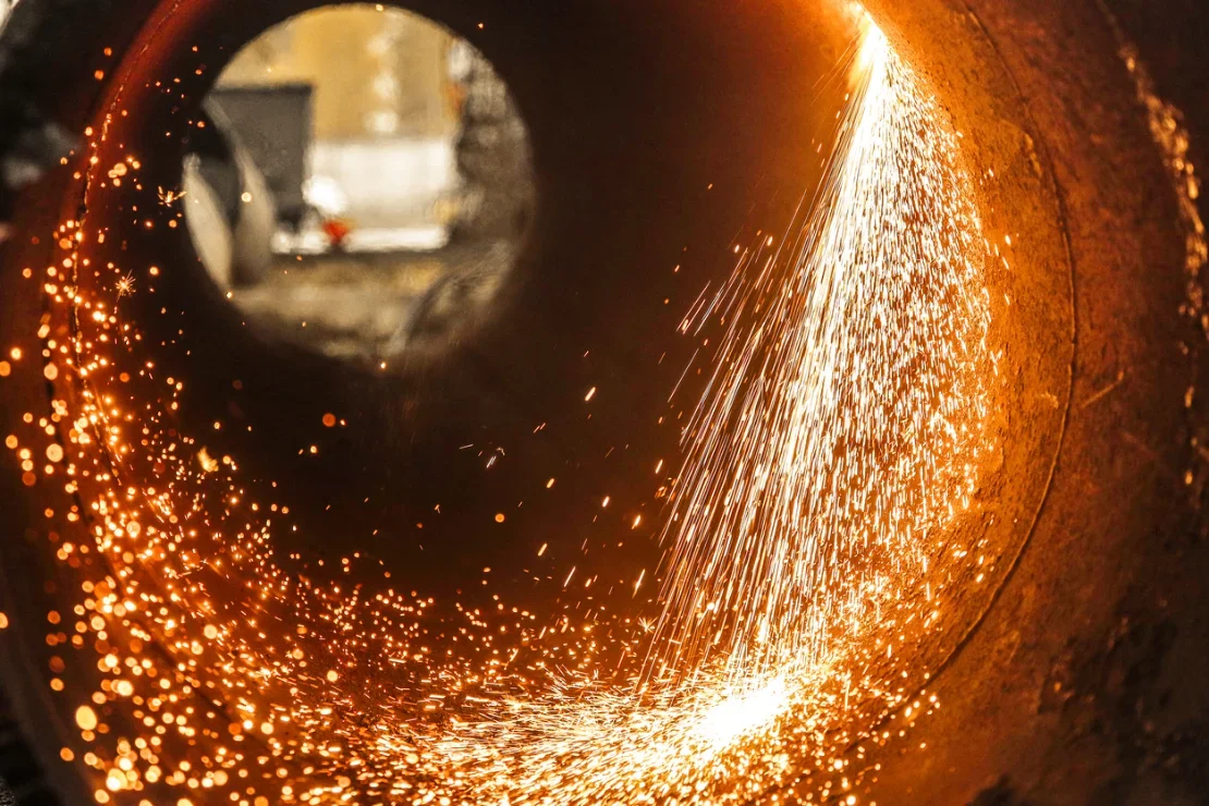 A view inside a pipe as it is cut, sparks flying