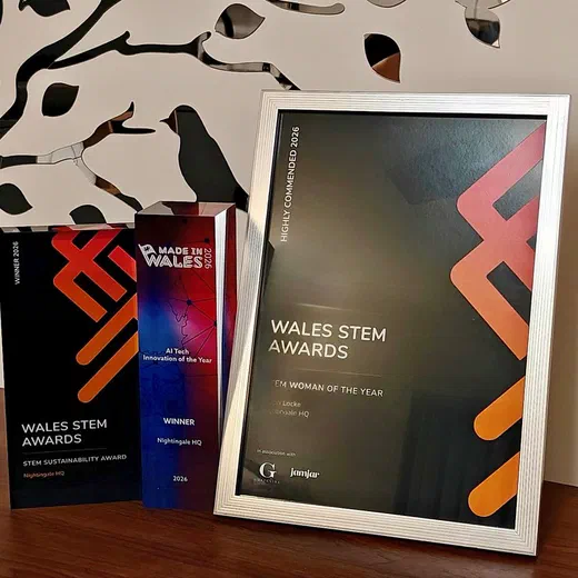 Nightingale HQ's three 2026 awards displayed together on a wooden shelf: the black Wales STEM Awards Sustainability Award winner plaque, the Made in Wales 2026 AI Tech Innovation of the Year winner trophy, and a silver-framed Wales STEM Awards Highly Commended certificate for STEM Woman of the Year awarded to Steph Locke.