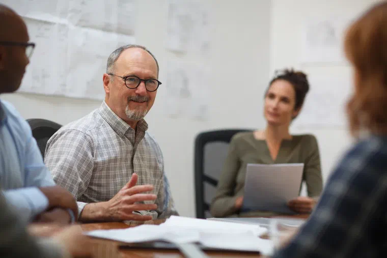 A finance and operations team reviewing production cost data in a manufacturing business meeting